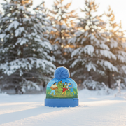 Blue beanie with a colorful design in a snowy landscape
