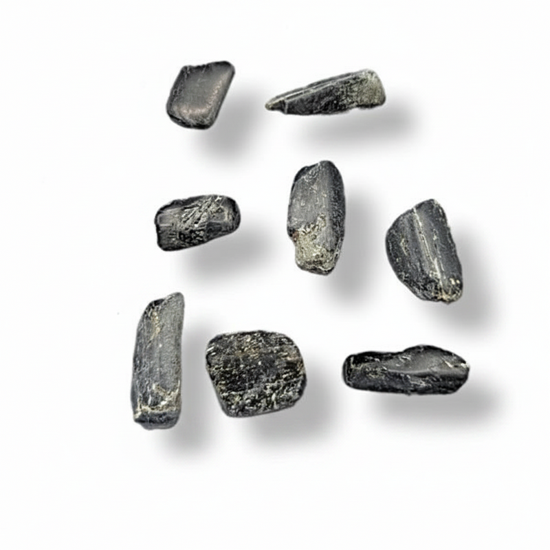 Seven small rough dark gray stone or glass pebble pieces arranged on a plain white background with soft drop shadows.