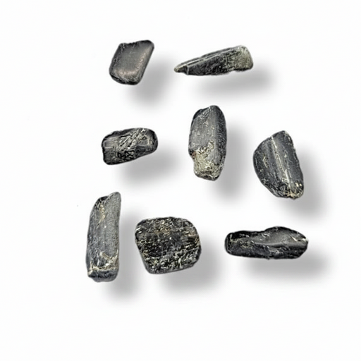 Seven small rough dark gray stone or glass pebble pieces arranged on a plain white background with soft drop shadows.