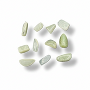 Green stones on a white surface 