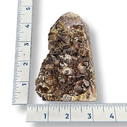 Amethyst next to a ruler on a white background