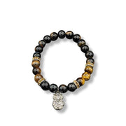 Mixed tiger's eye beaded bracelet with a silver owl charm on a white background