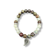 Beaded bracelet with leaf charm on a white background