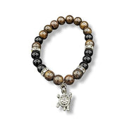 Bracelet with turtle charm on a white background