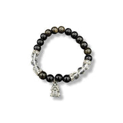 Black beaded bracelet with silver charm on a white background