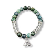 Bracelet with moss agate and clear quartz beads and a silver Trinity knot charm on a white background