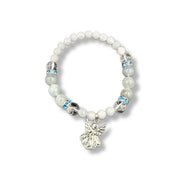 Bracelet with white beads and angel charm on a white background