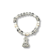 Bracelet with pearls and a Buddha charm on a white background