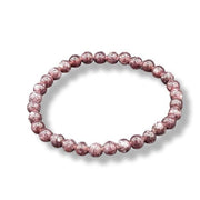 Pink beaded bracelet on a white background