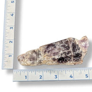 Amethyst next to a ruler on a white background