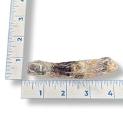 Amethyst next to a ruler on a white background