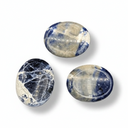 Sodalite worry stones on a white background