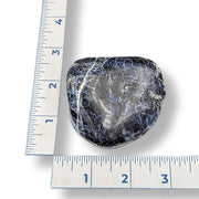 Sodalite next to a ruler on a white background