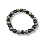 Black and gold beaded bracelet on a white background