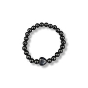 Black beaded bracelet with a heart-shaped clasp on a white background