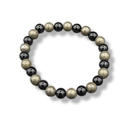 Beaded bracelet with black, gold, and silver beads on a white background