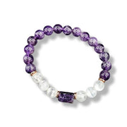 Purple and white beaded bracelet on a white background