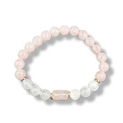 Rose quartz beaded bracelet with gold accents and selenite beads on a white background
