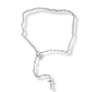 Pearl rosary necklace with a cross on a white background