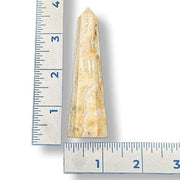 Crystal tower with a ruler on a white background