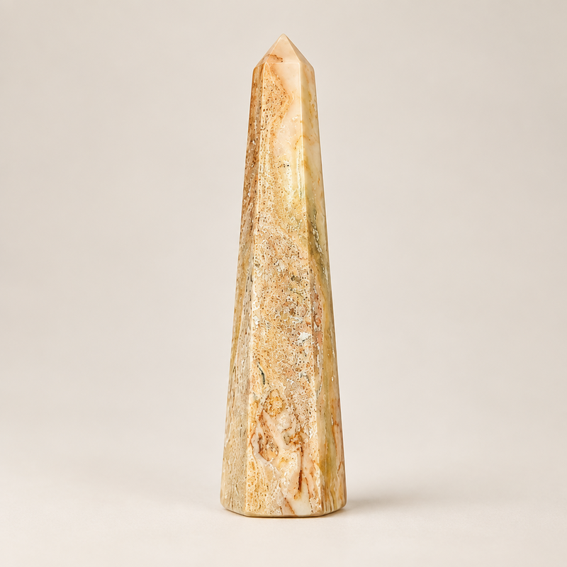 An agate obelisk on a white background.