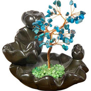 Decorative stone base with a tree made of blue and green stones on a white background