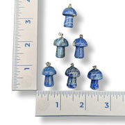 Blue mushroom-shaped objects with a ruler for scale on a white background