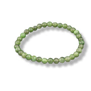 Green beaded bracelet on a white background