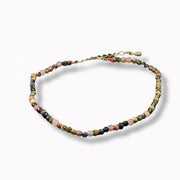 Beaded anklet with multicolored beads on a white background