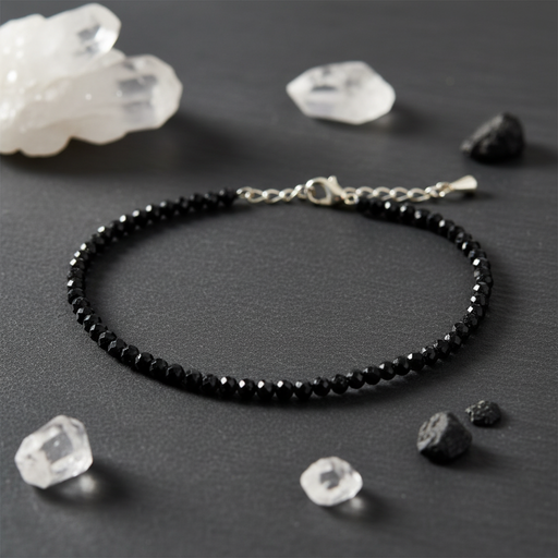 Black beaded anklet on a dark surface with crystals around