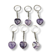 Set of six purple heart-shaped keychains on a white background