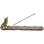 Incense burner with wolf figurine and incense stick on a white background