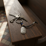 Keychain with a St. Michael token on a wooden surface