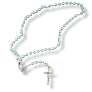 Blue glass pearl rosary with a silver cross on a white background