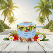Box of HEM Coconut Incense Cones on a wooden surface with coconuts and flowers, palm trees in the background.