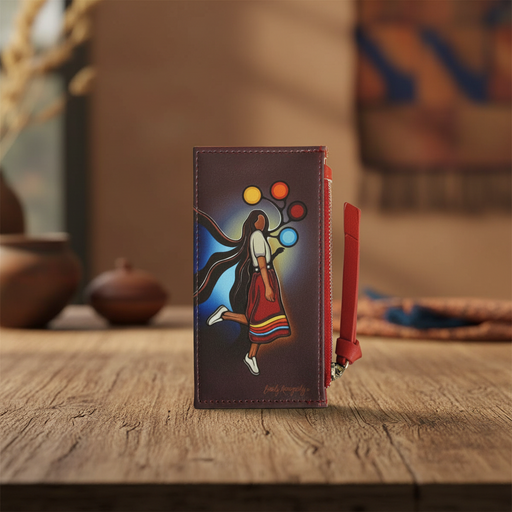 A dark brown leather wallet with a red wristlet strap, featuring a colorful hand-painted illustration of a dancer on a wooden table.