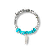 Bracelet with turquoise beads and a feather charm on a white background