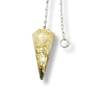 Citrine pendulum on a white background