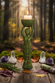 Green figure holding a candle in a forest setting with crystals and leaves on a wooden surface.