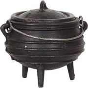 Black cast iron cauldron with lid on a white background