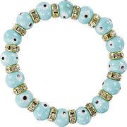 Bracelet with light blue beads and gold accents on a white background