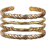 Tri-color twisted metal bracelet on a white background