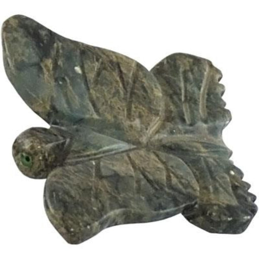 Carved stone butterfly figure on a white background