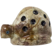 Decorative stone object with black spots on a white background