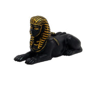 Black and gold sphinx figurine on a white background