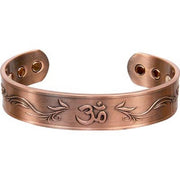 Copper bracelet with engraved design on a white background