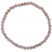 A beaded bracelet made of round pink rose quartz stones laid out in a circle.