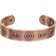 Copper bracelet with embossed symbols on a white background