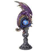 Decorative object with dragon design and glowing blue center on a white background