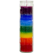 Stacked multicolored candle in a glass container on a white background